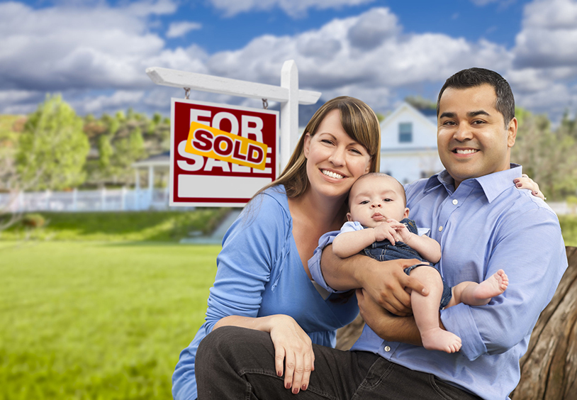 Happy mixed race family who just sold their fire damaged home.