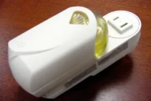 A Glade plug-in air freshener that can be plug into a wall outlet to emit a gentle fragrance.