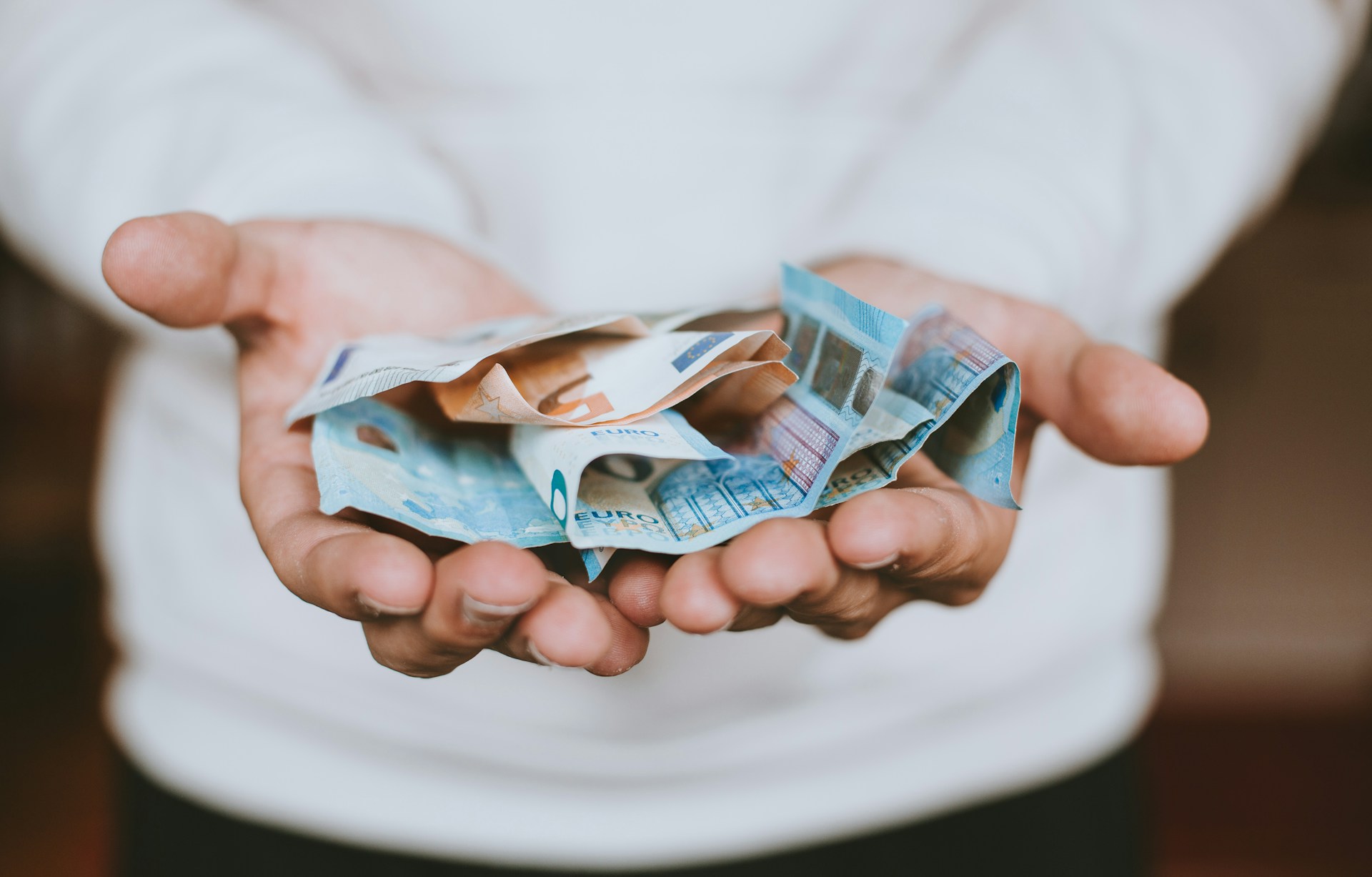 Hands with donation money
